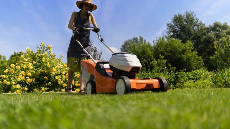 Woman mowing grass