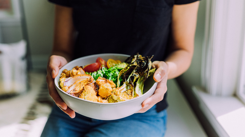 Woman holding a plant-based meal