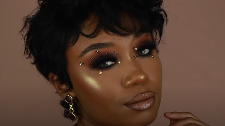 Black woman with gold eye embelishments