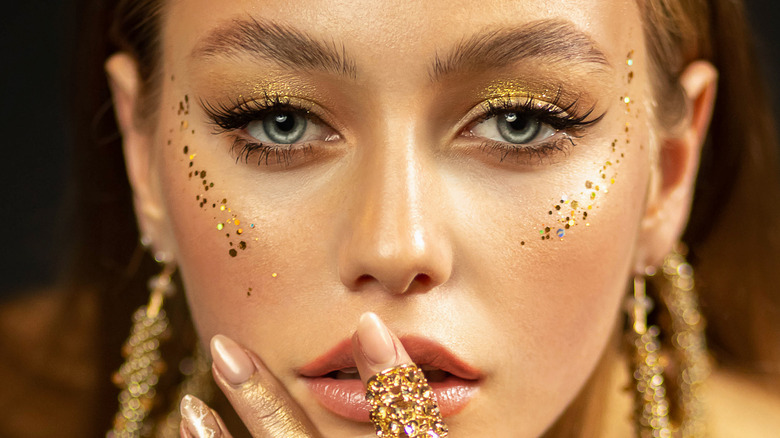 woman with gold glitter on her face