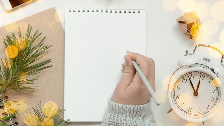 woman writing on a notepad