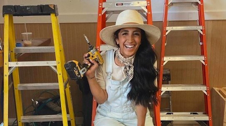 Veronica Valencia Hughes sitting on ladder