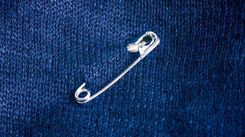 Safety pin on blue fabric