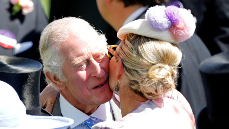 Zara and Charles hugging 