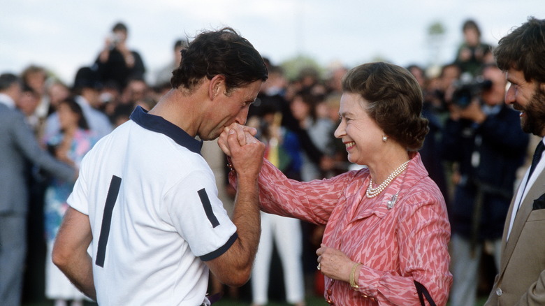 Charles kissing the queen's hand 