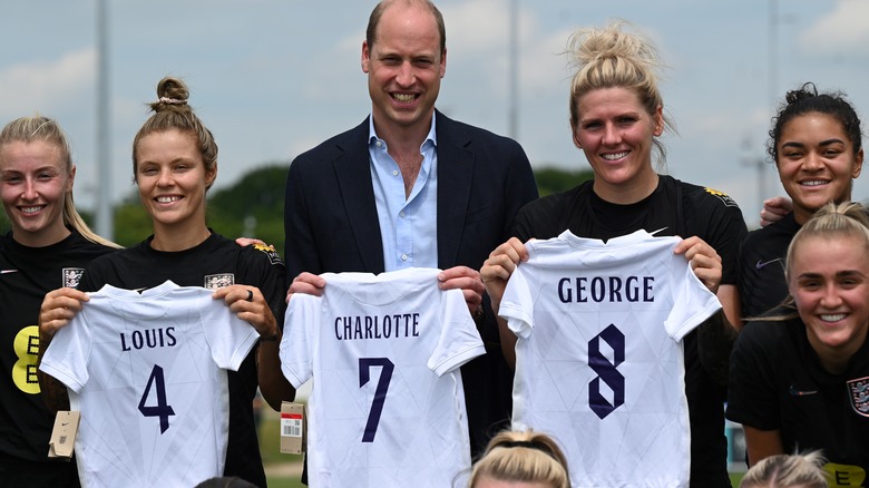 Prince William smiling with the women's England soccer team