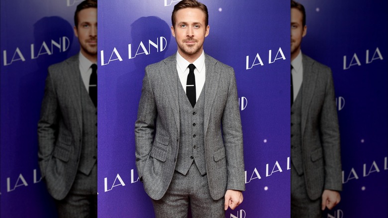 Ryan Gosling posing in a suit