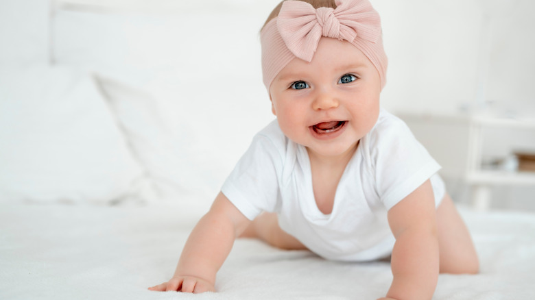 Baby girl in white tshirt and pink bow