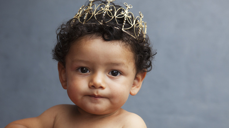 Baby boy wearing a golden crown