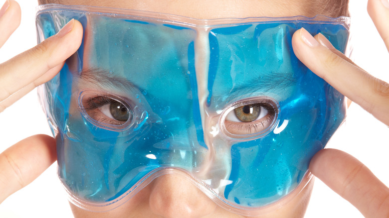 Woman with blue gel mask on eyes