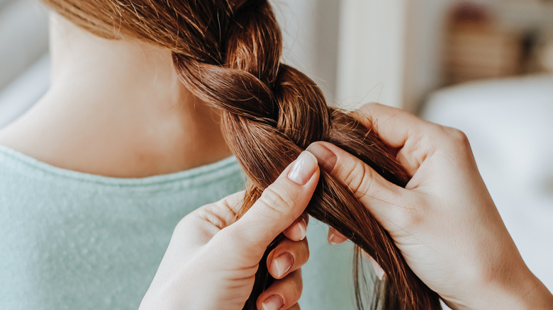 Woman having her hair braided