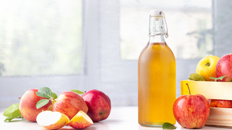 apples and a bottle of apple cider vinegar