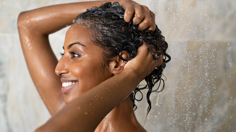 woman smiling and washing hair