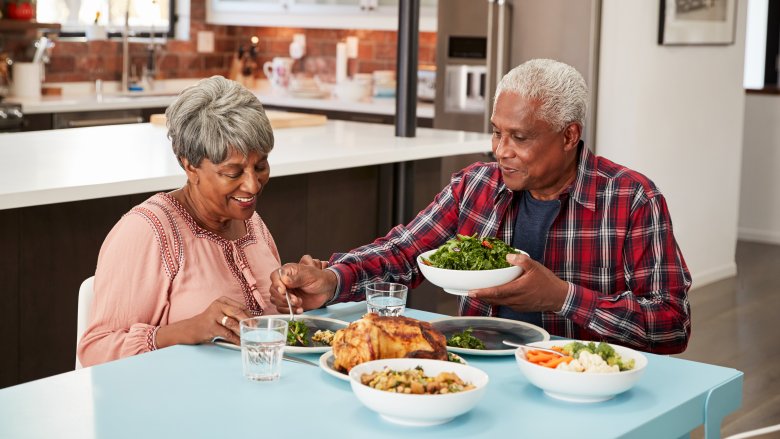 A senior couple eating dinner