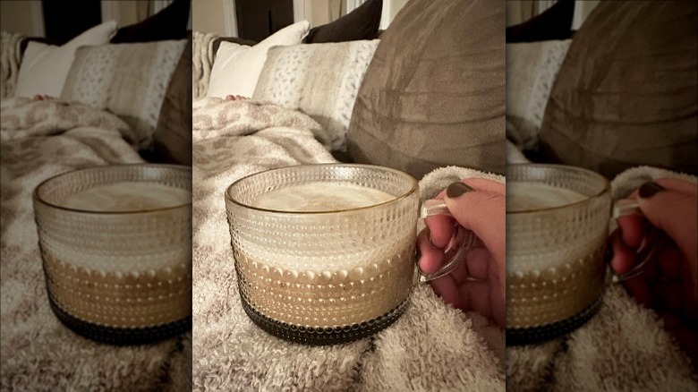 Woman holding a clear mug filled with a Clevr Blend latte