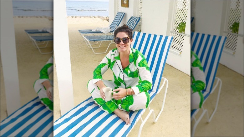 Woman wearing pjs and sitting on a lounge chair