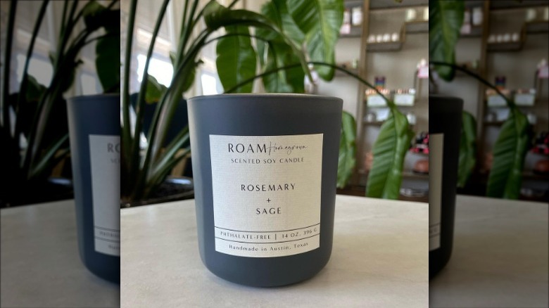 Rosemary + Sage candle sitting on a table