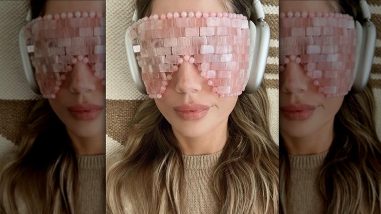 Woman wearing a rose quartz eye mask