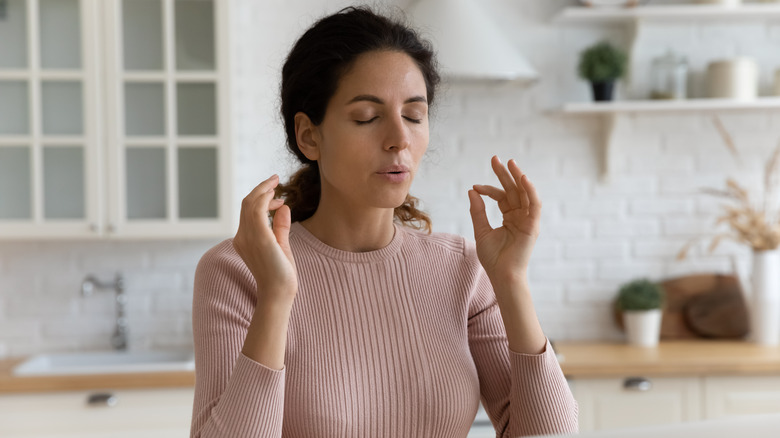 woman meditates after stressful work