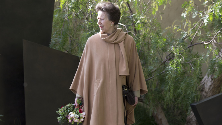 Princess Anne standing in a garden