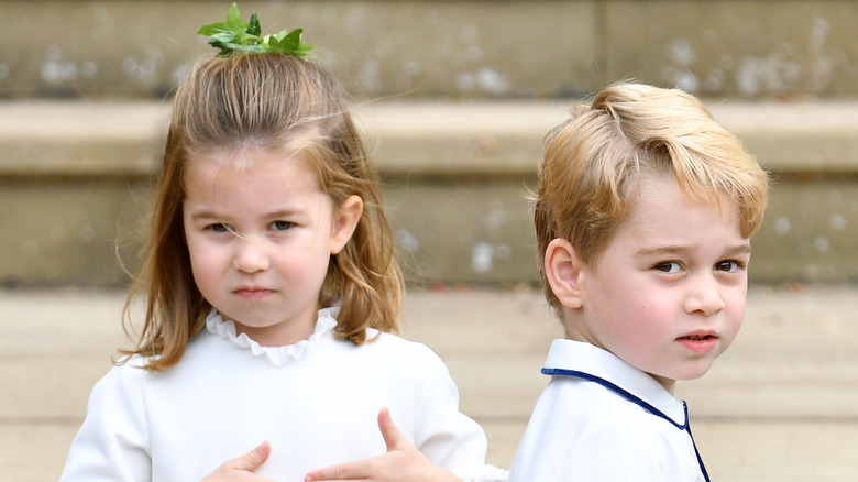 Princess Charlotte standing with Prince George