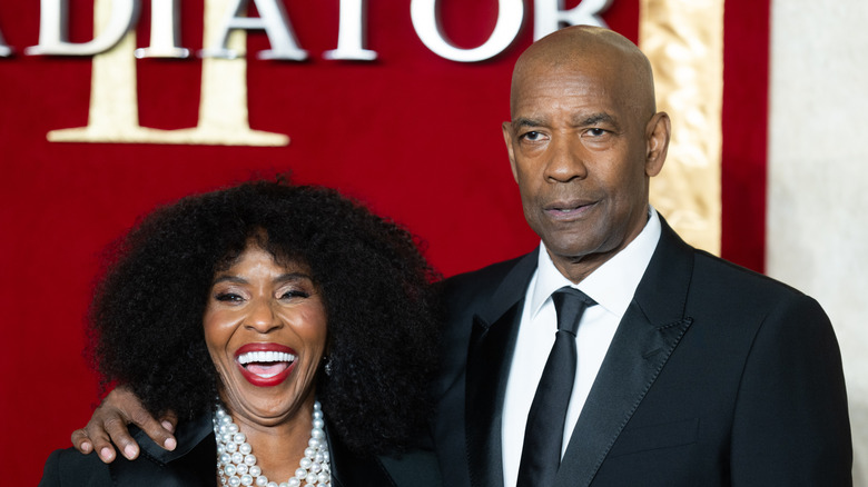 Denzel Washington and Pauletta Washington posing at the "Gladiator II" premiere in black attire