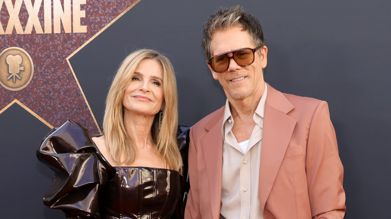 Kevin Bacon in peach suit with Kyra Sedgwick in leather dress at the 2024 "MAXXXINE" premiere