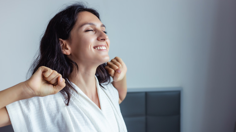 Woman waking up and stretching