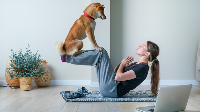 Woman doing exercise with her dog