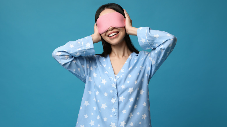 Woman wearing pajamas and an eye mask