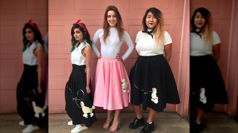 Social media image of three women in white shirts and poodle skirts