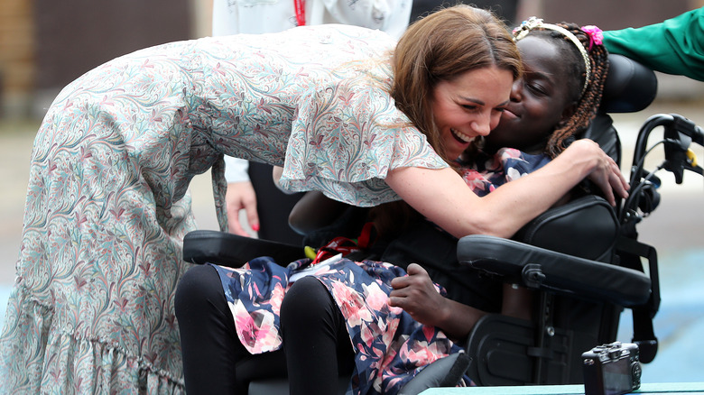 Kate Middleton hugging girl