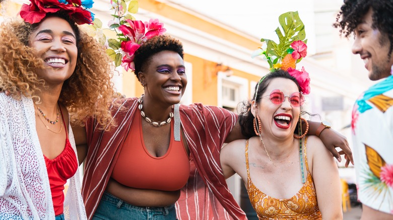 Women wearing flowers laughing together