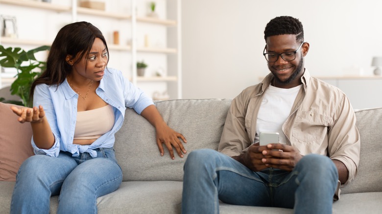 Woman mad at man distracted by phone