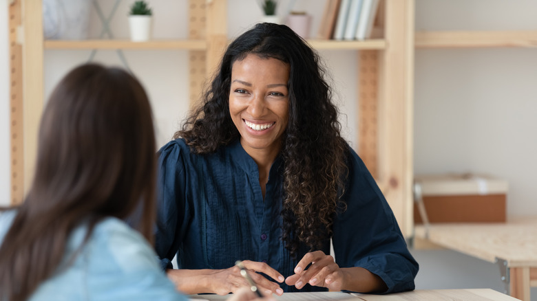 Women smiling at woman