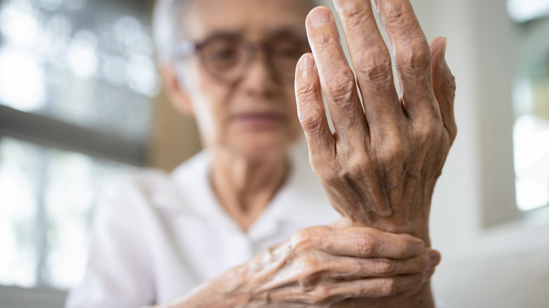 Elderly person experiencing joint pain