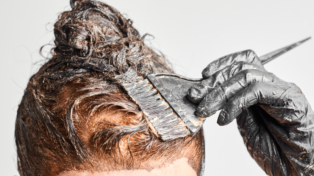 woman applying hair dye