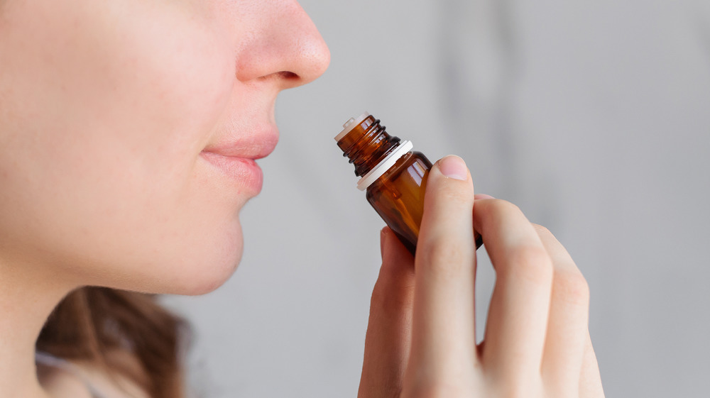 woman holding essential oils