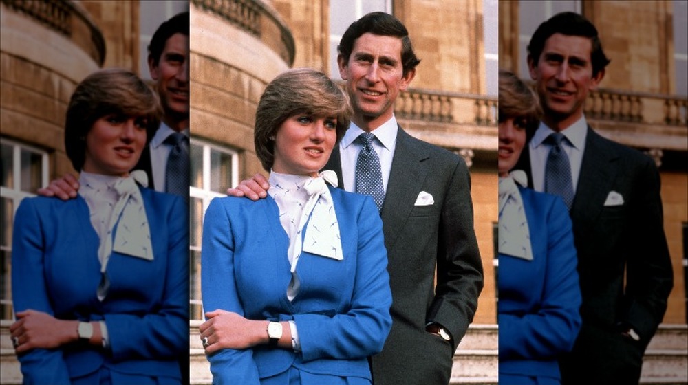 Prince Charles with his hand on Princess Diana's shoulder