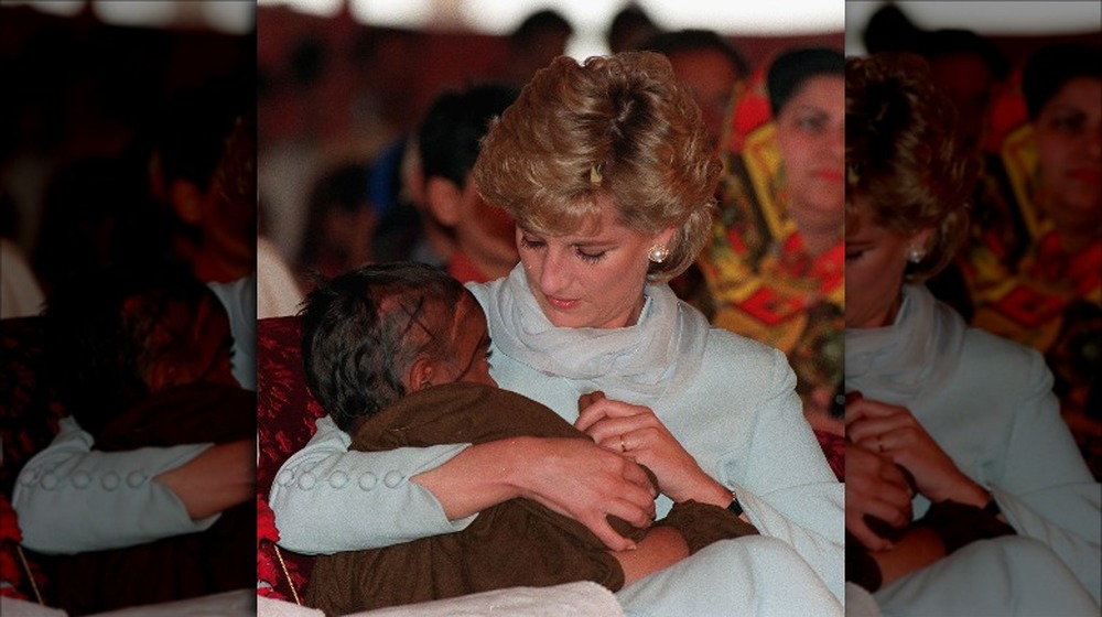 Princess Diana holding a child
