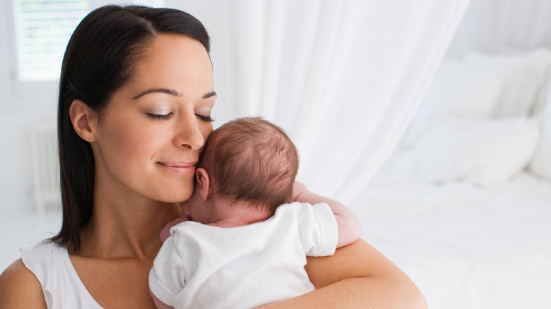 mother holding infant baby