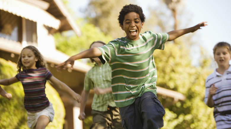 Group of children laughing and running