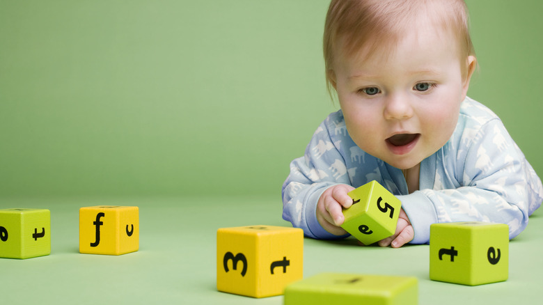 Baby playing with alphabet blocks