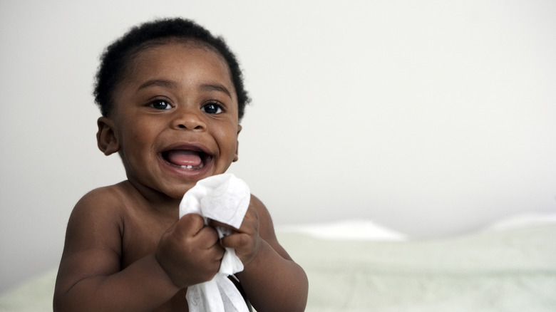 Smiling baby boy against a white background