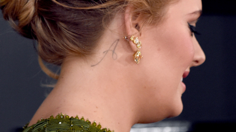 Adele's neck tattoo of an "A"