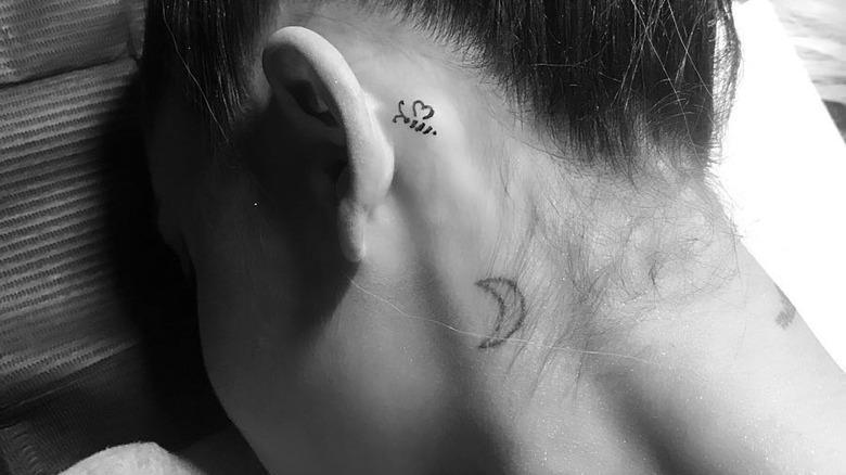 Ariana Grande's neck tattoo of a crescent moon