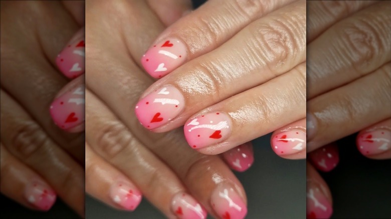 Short pink ombré nails with red hearts and polka dots