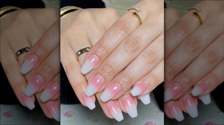 Woman posing with white-to-pink ombré nails