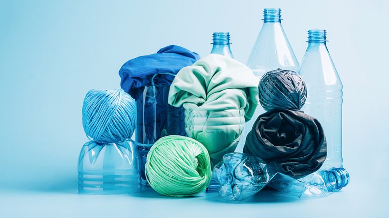 Plastic water bottles and synthetic fibers against a blue background