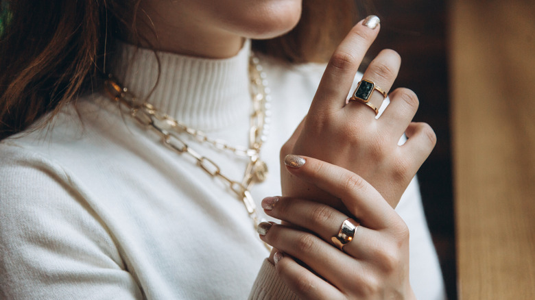 Woman wearing chunky gold jewelry